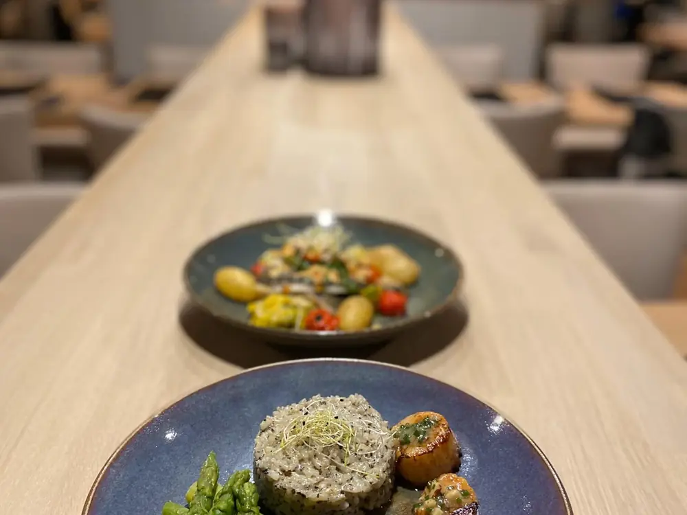 Deux assiettes posées sur le bar en bois clair.